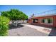 Expansive backyard featuring mature trees, a brick patio and low maintenance desert landscaping at 6258 E Duncan St, Mesa, AZ 85205