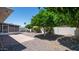 Large backyard featuring mature shade trees, screened in porch, and low maintenance desert landscaping at 6258 E Duncan St, Mesa, AZ 85205