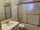 This neutral bathroom features a shower/tub, white vanity and a gold framed mirror at 6258 E Duncan St, Mesa, AZ 85205