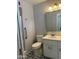 A neutral bathroom features a walk-in shower, patterned flooring and a standard vanity at 6258 E Duncan St, Mesa, AZ 85205