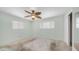 This bedroom features two windows that provide natural light, and it also includes a ceiling fan at 6258 E Duncan St, Mesa, AZ 85205
