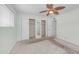This bedroom boasts two closets with mirrored doors and a ceiling fan for added comfort at 6258 E Duncan St, Mesa, AZ 85205