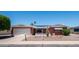 Charming home featuring desert landscaping, solar panels, and an attached two-car garage at 6258 E Duncan St, Mesa, AZ 85205