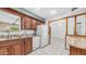 Spacious kitchen featuring white appliances, tile floors, and wood cabinets at 6258 E Duncan St, Mesa, AZ 85205