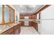 Well-appointed kitchen with wood cabinets, granite countertops, and white appliances at 6258 E Duncan St, Mesa, AZ 85205