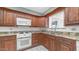 Close-up of a kitchen with wood cabinets and light countertops at 6258 E Duncan St, Mesa, AZ 85205