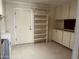 Bright laundry room features built-in shelves, storage cabinets, and durable flooring at 6258 E Duncan St, Mesa, AZ 85205