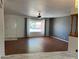 This living room features laminate flooring, a front door and a picture window at 6258 E Duncan St, Mesa, AZ 85205