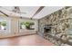 Relaxing living room with a stone fireplace, exposed wood beams, and ample natural light at 6258 E Duncan St, Mesa, AZ 85205