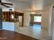 This living room features tile flooring and leads to both the kitchen and front room at 6258 E Duncan St, Mesa, AZ 85205