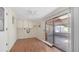Bright sunroom with wood floors and a ceiling fan leading to an outdoor patio at 6258 E Duncan St, Mesa, AZ 85205