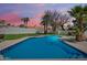 Backyard view of the sparkling pool surrounded by lush landscaping and privacy fence at 7624 E Larkspur Dr, Scottsdale, AZ 85260