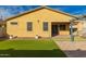 Cozy backyard featuring artificial turf, gravel landscaping, and an open patio area at 10363 W Rosewood Ln, Peoria, AZ 85383