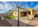 A backyard with a shaded patio, low-maintenance turf, and a paver extension at 10363 W Rosewood Ln, Peoria, AZ 85383