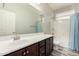 This bathroom offers a shower and tub combination with a single sink vanity and a window at 10363 W Rosewood Ln, Peoria, AZ 85383