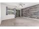 Bedroom featuring neutral walls, plush carpeting, and a rustic wood accent wall at 10363 W Rosewood Ln, Peoria, AZ 85383