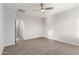 Spacious bedroom with neutral carpet, a ceiling fan, and an ensuite bathroom at 10363 W Rosewood Ln, Peoria, AZ 85383