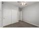 This bedroom offers neutral carpet, a ceiling fan, and a door leading to another room at 10363 W Rosewood Ln, Peoria, AZ 85383