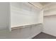 Walk-in closet with ample shelving and hanging space for optimal storage solutions at 10363 W Rosewood Ln, Peoria, AZ 85383