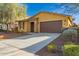 Inviting single-Gathering home features a stone-accented entryway, attached two-car garage, and well-manicured front yard at 10363 W Rosewood Ln, Peoria, AZ 85383