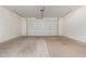 This is an empty two car garage with concrete floors and a garage door at 10363 W Rosewood Ln, Peoria, AZ 85383