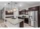 Beautiful kitchen featuring stainless steel appliances, a large island, and wood flooring at 10363 W Rosewood Ln, Peoria, AZ 85383
