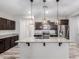 Modern kitchen featuring a large island with stone countertop and stainless steel appliances at 10363 W Rosewood Ln, Peoria, AZ 85383