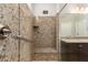 Elegant shower with glass doors, marble-style tile, bench seating, and convenient grab bar at 10363 W Rosewood Ln, Peoria, AZ 85383