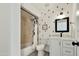 Clean, updated bathroom featuring cactus decals, a shower with neutral tile and white vanity at 10428 S 43Rd St, Phoenix, AZ 85044