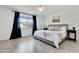 Spacious bedroom with an accent wall, a ceiling fan, and views of the outdoors at 10428 S 43Rd St, Phoenix, AZ 85044