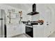 Bright kitchen with stainless steel appliances, white cabinets, and floating shelves at 10428 S 43Rd St, Phoenix, AZ 85044