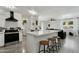 Modern kitchen with white cabinets, a breakfast bar, and stainless steel appliances at 10428 S 43Rd St, Phoenix, AZ 85044