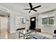Bright living room featuring a ceiling fan, gray sofa, and access to the bedroom at 10428 S 43Rd St, Phoenix, AZ 85044