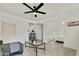 Open-concept living room with light gray wood floors, a ceiling fan, and neutral decor at 10428 S 43Rd St, Phoenix, AZ 85044