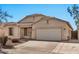 Charming single-story home featuring a well-maintained yard, neutral stucco, and a two-car garage on a sunny day at 10775 W Davis Ln, Avondale, AZ 85323
