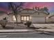 Charming single-story home featuring a well-maintained desert landscape, two-car garage, and neutral color scheme at 10775 W Davis Ln, Avondale, AZ 85323
