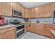 Well-equipped kitchen featuring stainless steel appliances and ample cabinet space with stone countertops at 10775 W Davis Ln, Avondale, AZ 85323