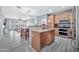 Open-concept kitchen with breakfast bar looking into dining and living areas at 10775 W Davis Ln, Avondale, AZ 85323
