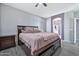 A lovely main bedroom with a ceiling fan, light grey walls, tile floor, and ensuite at 10775 W Davis Ln, Avondale, AZ 85323