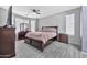 This main bedroom features a ceiling fan, light grey walls, and dark wood furniture at 10775 W Davis Ln, Avondale, AZ 85323