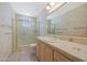 Bathroom with a glass shower, light wood cabinets, and tile flooring at 11099 E Desert Vista Dr, Scottsdale, AZ 85255