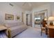 Bedroom with carpet, a twin size bed, a desk, and large mirrored closet doors at 11099 E Desert Vista Dr, Scottsdale, AZ 85255