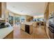 Well-appointed kitchen with stone floors and stainless steel appliances with easy access to the living room at 11099 E Desert Vista Dr, Scottsdale, AZ 85255