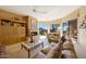Cozy living room with fireplace, built-in shelving, and picture windows framing the beautiful desert mountain views at 11099 E Desert Vista Dr, Scottsdale, AZ 85255