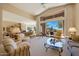 Spacious living room with plush furnishings, large windows showcasing desert landscape, and a bright, inviting atmosphere at 11099 E Desert Vista Dr, Scottsdale, AZ 85255
