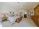 Spacious main bedroom with a ceiling fan, carpet floors and multiple pieces of furniture and fixtures at 11099 E Desert Vista Dr, Scottsdale, AZ 85255