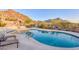 Beautiful in-ground community pool area with mountain views and lounge seating at 11099 E Desert Vista Dr, Scottsdale, AZ 85255