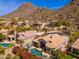 Stunning aerial view of luxury homes with private pools nestled in a desert mountain community at 11187 E De La O Rd, Scottsdale, AZ 85255