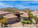 Aerial view of a home with desert landscape and a tile roof at 11187 E De La O Rd, Scottsdale, AZ 85255