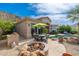 Backyard patio offers a fire pit, barbecue area, and sparkling pool with views of the surrounding landscape at 11187 E De La O Rd, Scottsdale, AZ 85255
